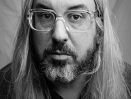 J Mascis mit Bart, Brille und langen Haaren